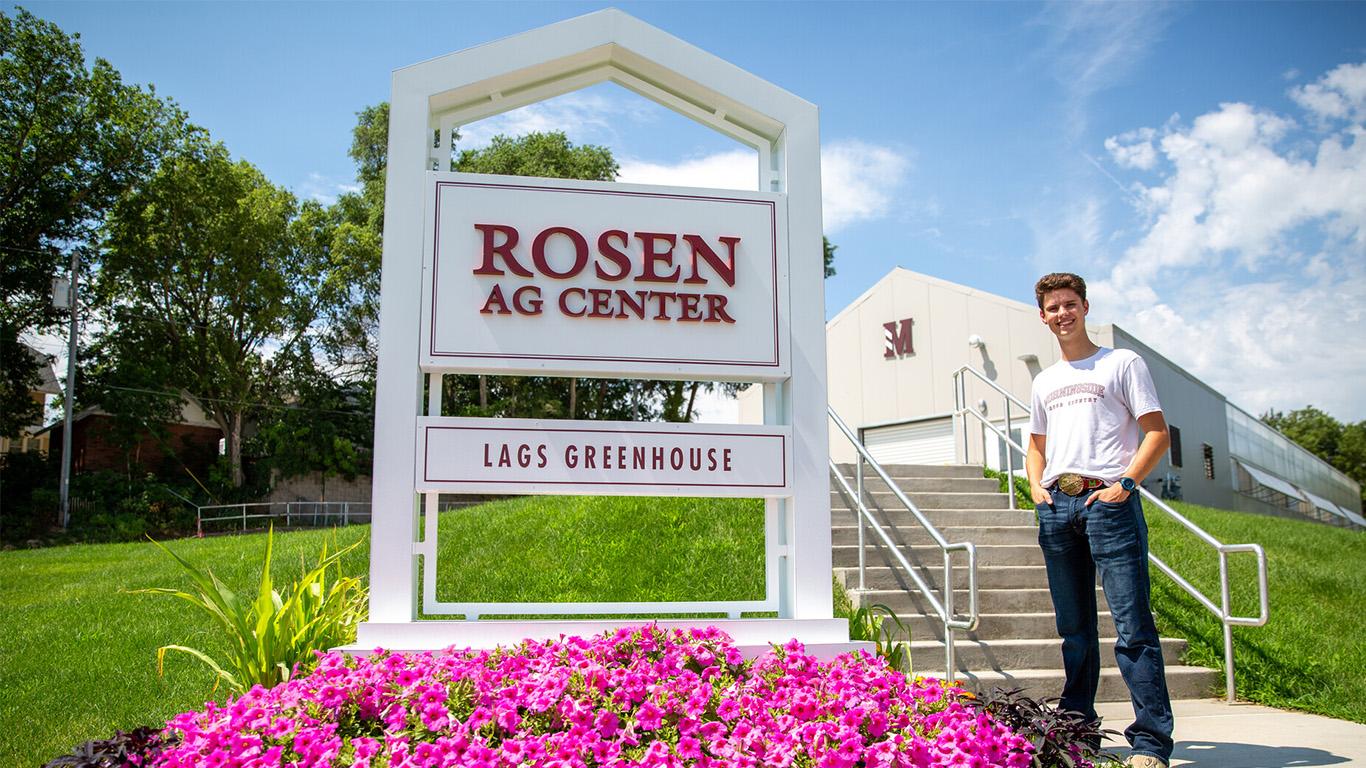 Student standing in front of Rosen Ag Center